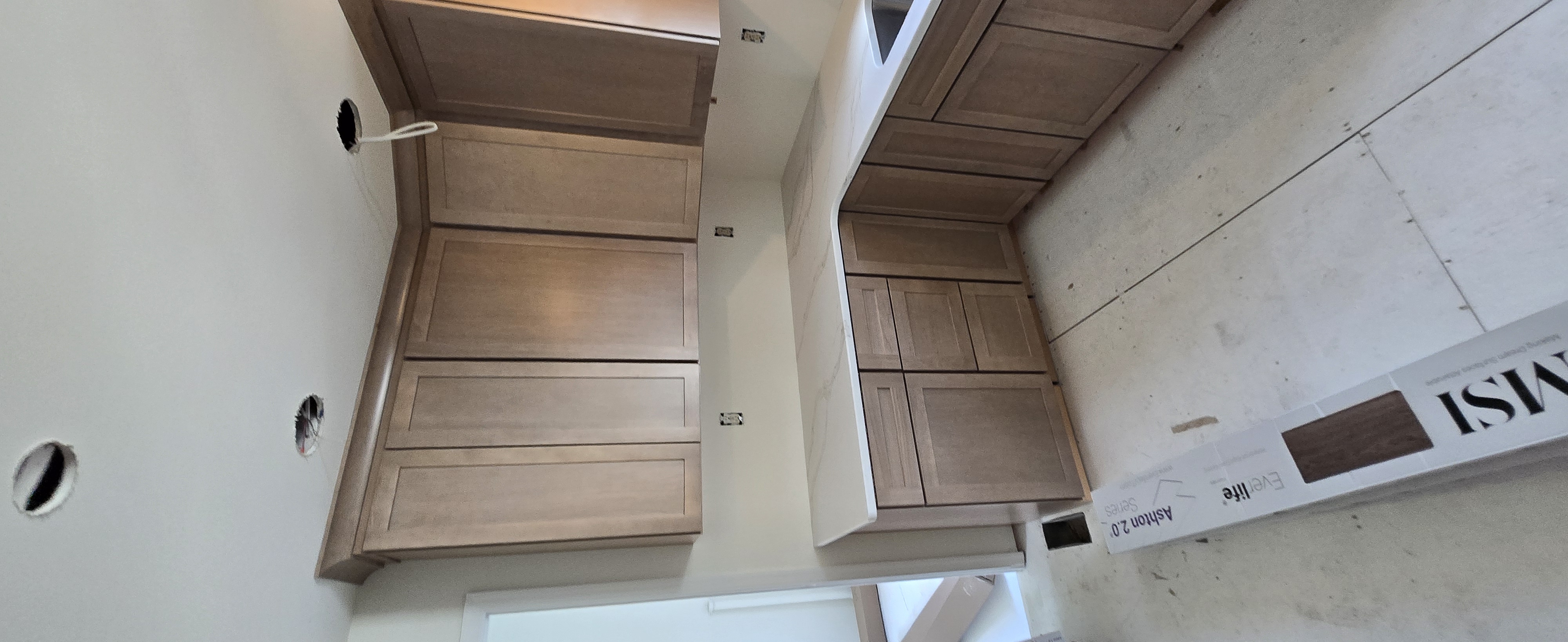 Craftsman fitting cabinet hardware in a woodworking shop